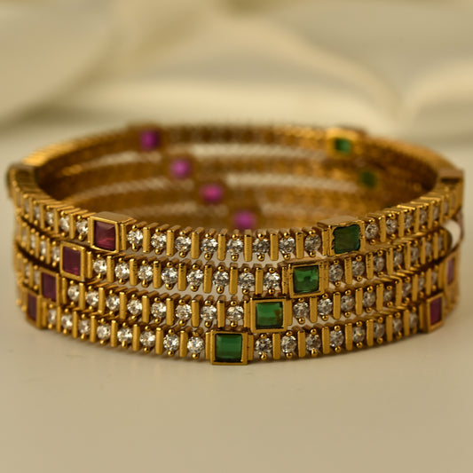 AD Bangle in antique gold polish with diamond like white stone highlighted with square cut green and ruby color stone 4pc bangles