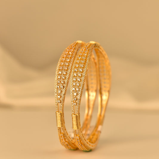 Real Gold like bangle with real diamond like stone on a beige background
