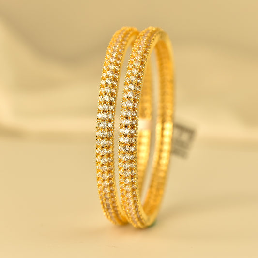 Real Gold like ad bangles with diamond-like stones on a gold background