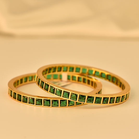 AD Bangle with Gold Polish looks like real Diamond bangle with square cut emerald green color stone arranged in beautiful box design