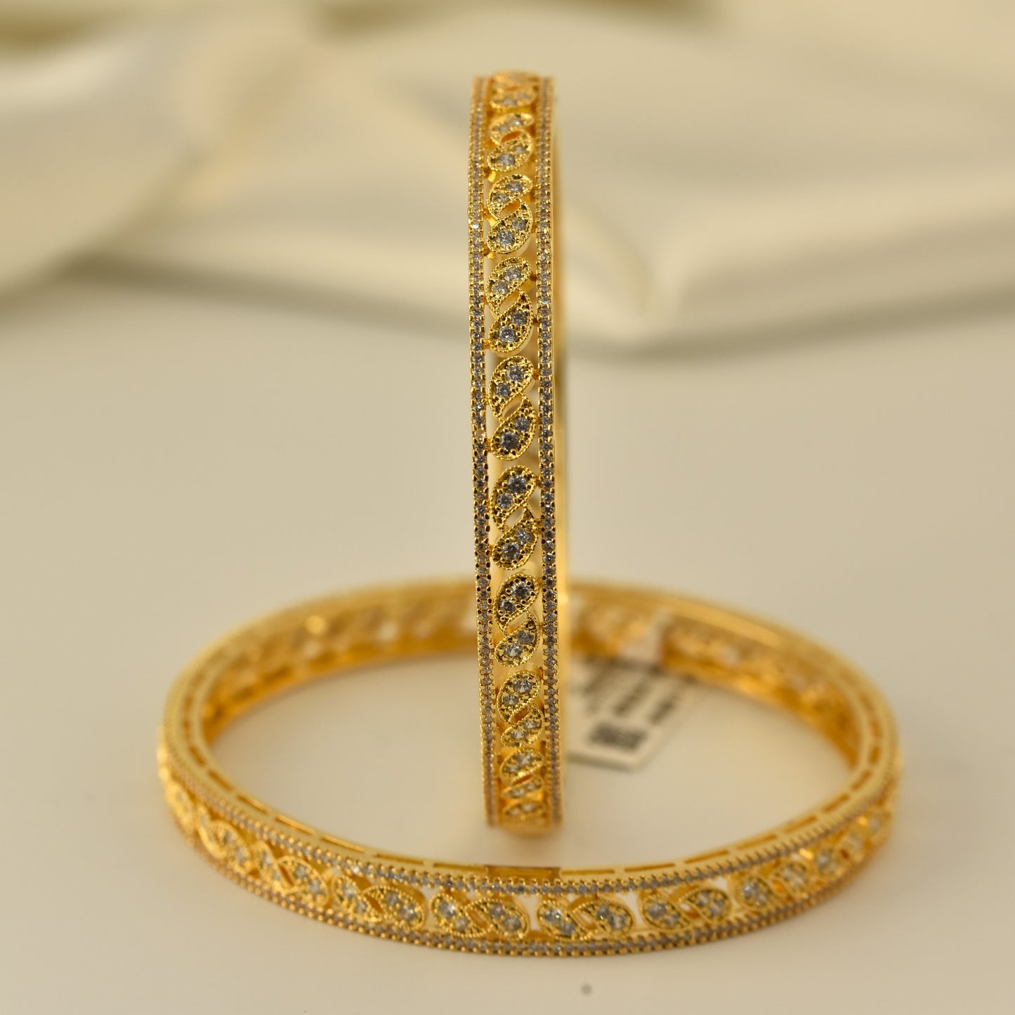 AD Bangle with Gold Polish looks like real Diamond bangle with white stone arranged in beautiful mango motif stylish design